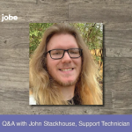 John Stackhouse headshot against wood grain with banner reading Q&A with John Stackhouse, Support Technician
